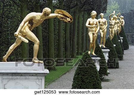 Stock Image - Gold sculptures in a garden, Herren Hausen Gardens, Hannover, Germany. Fotosearch