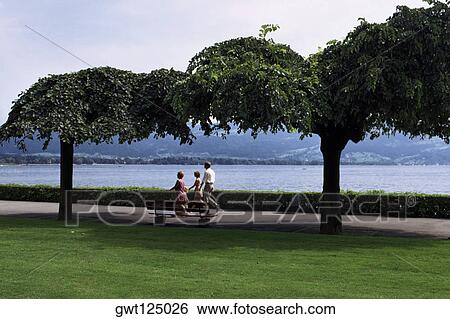 Parents and their two children walking in a park, Lindau, Germany View Large Photo Image Stock Photograph - Parents and their two children walking in a park, Lindau, Germany. Fotosearch