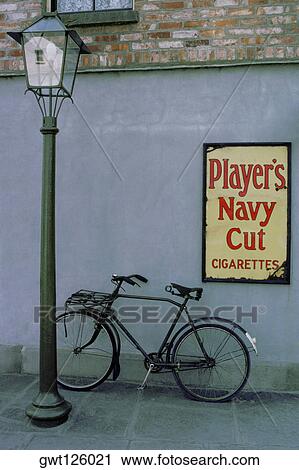 Stock Image - Close-up of a bicycle leaning against a wall, Republic of Ireland. Fotosearch