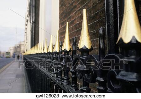 Stock Photo - Close-up of a spike fence on the sidewalk, Republic of Ireland. Fotosearch