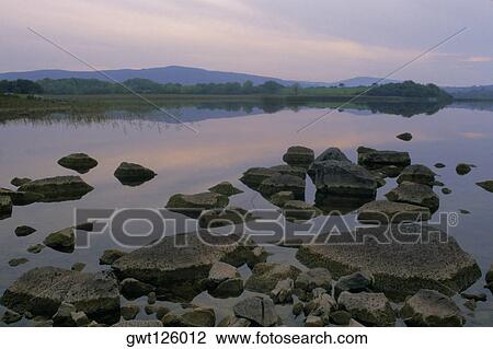 Rocks in a lake, Ross Lake, County Galway, Republic of Ireland View Large Photo Image Stock Image - Rocks in a lake, Ross Lake, County Galway, Republic of Ireland. Fotosearch
