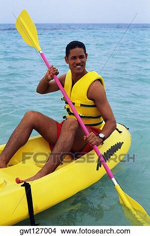 A man is boating in an inflatable kayak, Discovery Bay, Jamaica View Large Photo Image Picture - A man is boating in an inflatable kayak, Discovery Bay, Jamaica. Fotosearch