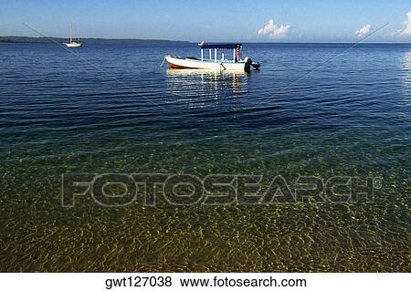 Stock Photo - A small boat is moored off the beach of Hedonism 2, Jamaica. Fotosearch
