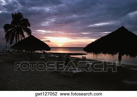 Stock Image - A thatched canopy is seen at Negril Beach, Jamaica. Fotosearch