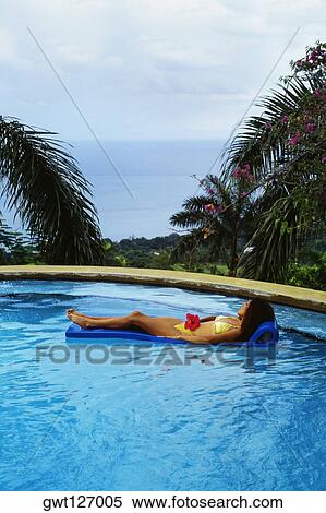 A woman is relaxing in a swimming pool at Destiny Villa, Jamaica View Large Photo Image Stock Photography - A woman is relaxing in a swimming pool at Destiny Villa, Jamaica. Fotosearch
