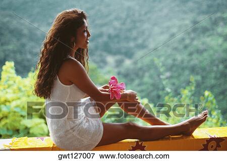 A young woman in white dress is sitting on a ledge, Destiny Villa, Jamaica View Large Photo Image Stock Photo - A young woman in white dress is sitting on a ledge, Destiny Villa, Jamaica. Fotosearch