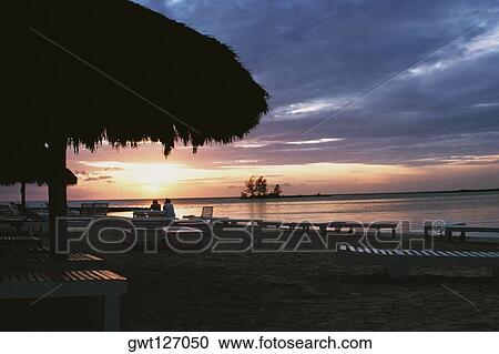 Silhouette of a thatched canopy is seen at Negril Beach, Jamaica View Large Photo Image Stock Image - Silhouette of a thatched canopy is seen at Negril Beach, Jamaica. Fotosearch