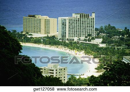 The Hilton Hotel on the island of Jamaica is located on a beautiful white sand beach View Large Photo Image Stock Photo - The Hilton Hotel on the island of Jamaica is located on a beautiful white sand beach. Fotosearch