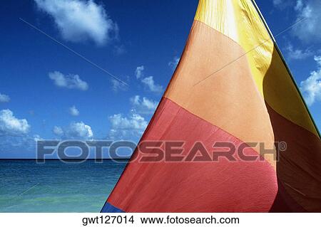 View of a colorful sail with sea in the background, Jamaica View Large Photo Image Picture - View of a colorful sail with sea in the background, Jamaica. Fotosearch