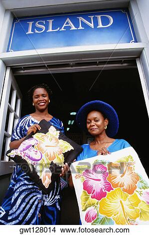 Low angle view of two women smiling at the camera, St. Kitts View Large Photo Image Picture - Low angle view of two women smiling at the camera, St. Kitts. Fotosearch