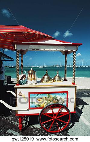 Side view of a cart with a brass lid and ice-cream cone placed on it, St. Martin View Large Photo Image Stock Photo - Side view of a cart with a brass lid and ice-cream cone placed on it, St. Martin. Fotosearch