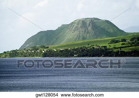 Picture - Side view of a lush mountain from a vast sea, St. Kitts, Leeward Islands, Caribbean. Fotosearch