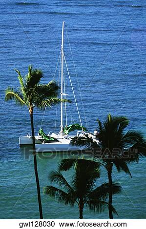 Stock Image - Side view of a sail boat moored into a bay, St. Maarten, Simpson Bay, Caribbean. Fotosearch