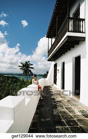 A woman is having a look over the dense trees from the balcony, San Juan, Puerto Rico View Large Photo Image Picture - A woman is having a look over the dense trees from the balcony, San Juan, Puerto Rico. Fotosearch