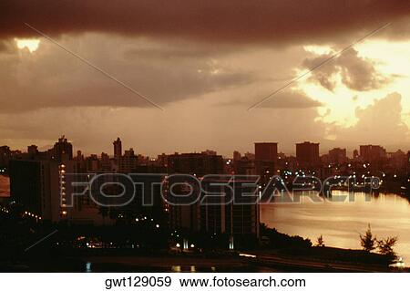 Stock Photo - Spectacular cityscape at sunset, Puerto Rico. Fotosearch