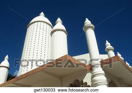 A prominent minaret of a Hindu temple is seen against the blue sky, Trinidad, Caribbean View Large Photo Image Stock Image - A prominent minaret of a Hindu temple is seen against the blue sky, Trinidad, Caribbean. Fotosearch
