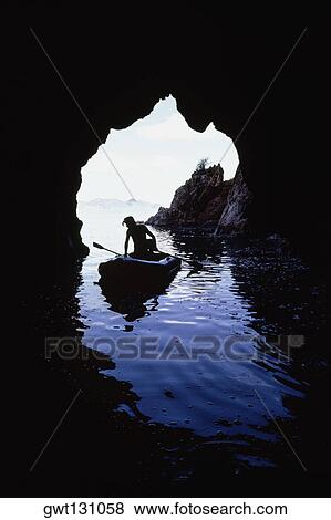 A man rowing a canoe seen through the cave, Treasure Island, Virgin Islands View Large Photo Image Stock Photo - A man rowing a canoe seen through the cave, Treasure Island, Virgin Islands. Fotosearch