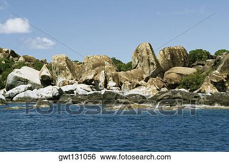 View of the beach flanked by rocks, Virgin Gorda, Virgin Islands View Large Photo Image Stock Photograph - View of the beach flanked by rocks, Virgin Gorda, Virgin Islands. Fotosearch