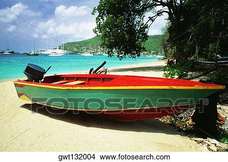 A boat is seen on a seashore on a sunny day, The Grenadines View Large Photo Image Picture - A boat is seen on a seashore on a sunny day, The Grenadines. Fotosearch