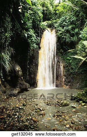 Stock Photography - A waterfall cascading through rocks from an altitude, St. Lucia. Fotosearch