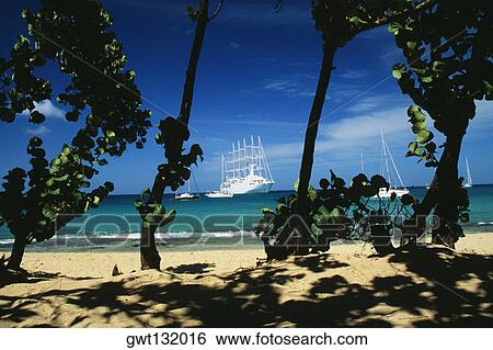 Boats are sailing on a calm sea, The Grenadines View Large Photo Image Stock Photograph - Boats are sailing on a calm sea, The Grenadines. Fotosearch