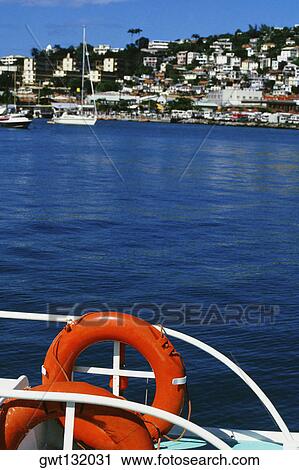 Bright life preservers are seen attached to a railing on a boat in Port de France, Martinique View Large Photo Image Stock Image - Bright life preservers are seen attached to a railing on a boat in Port de France, Martinique. Fotosearch