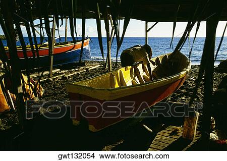 Fishing boats protected by simple thatch shelters, Martinique View Large Photo Image Picture - Fishing boats protected by simple thatch shelters, Martinique. Fotosearch