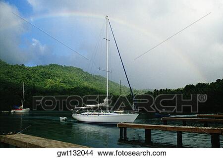 Rainbow is seen over a harbor, St. Lucia, Caribbean View Large Photo Image Picture - Rainbow is seen over a harbor, St. Lucia, Caribbean. Fotosearch