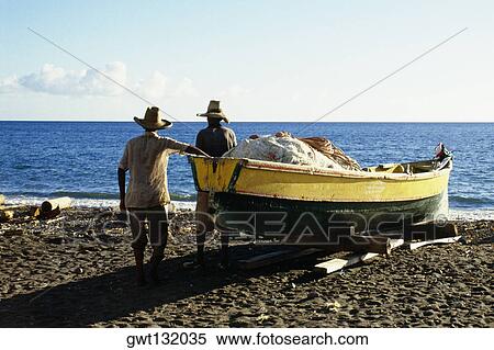 Rear view of two men near a boat on a beach on the island of Martinique, Caribbean View Large Photo Image Stock Photography - Rear view of two men near a boat on a beach on the island of Martinique, Caribbean. Fotosearch