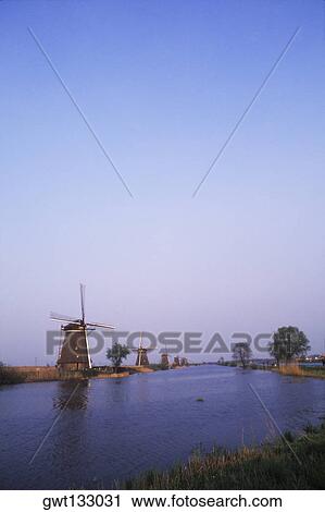 Traditional windmill along a pond, Amsterdam, Netherlands View Large Photo Image Stock Image - Traditional windmill along a pond, Amsterdam, Netherlands. Fotosearch