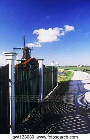 Traditional windmill in a village, Amsterdam, Netherlands View Large Photo Image Stock Image - Traditional windmill in a village, Amsterdam, Netherlands. Fotosearch