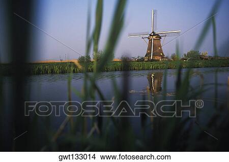 Traditional windmill near a pond, Amsterdam, Netherlands View Large Photo Image Picture - Traditional windmill near a pond, Amsterdam, Netherlands. Fotosearch