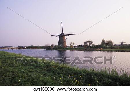 Traditional windmill near a pond, Amsterdam, Netherlands View Large Photo Image Stock Photograph - Traditional windmill near a pond, Amsterdam, Netherlands. Fotosearch