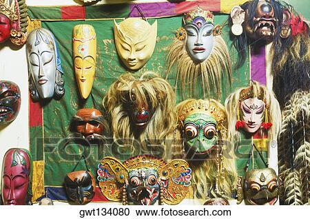 Stock Image - Close-up of masks hanging on a wall, Bali, Indonesia. Fotosearch