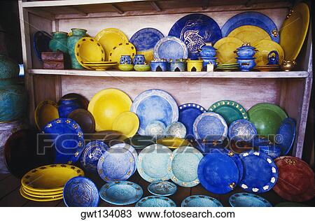 Stock Image - Close-up of plates on a shelf, Bali, Indonesia. Fotosearch