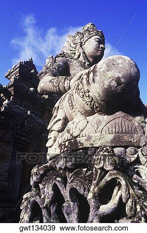 Stock Photo - Low angle view of a statue in front of a temple, Bali, Indonesia. Fotosearch