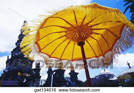 Low angle view of a sunshade in front of a temple, Bali, Indonesia View Large Photo Image Stock Photograph - Low angle view of a sunshade in front of a temple, Bali, Indonesia. Fotosearch