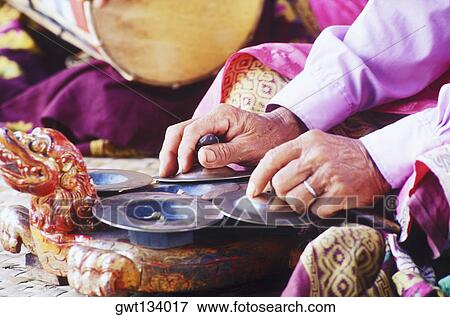 Mid section view of a person playing cymbals, Bali, Indonesia View Large Photo Image Stock Photo - Mid section view of a person playing cymbals, Bali, Indonesia. Fotosearch