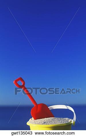 Close-up of a shovel in a sand pail View Large Photo Image Stock Image - Close-up of a shovel in a sand pail. Fotosearch