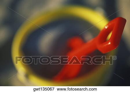 Close-up of a shovel in a sand pail View Large Photo Image Stock Photo - Close-up of a shovel in a sand pail. Fotosearch