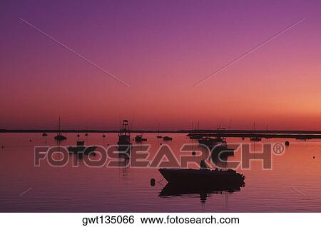 Silhouette of boats moored in a river, Cape Cod, Cape Cod, Massachusetts, USA View Large Photo Image Stock Photograph - Silhouette of boats moored in a river, Cape Cod, Cape Cod, Massachusetts, USA . Fotosearch