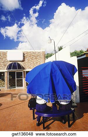 Rear view of two people sitting under an umbrella, Caribbean View Large Photo Image Stock Photo - Rear view of two people sitting under an umbrella, Caribbean. Fotosearch