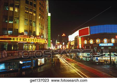 Buildings in a city lit up at night, China View Large Photo Image Stock Image - Buildings in a city lit up at night, China. Fotosearch