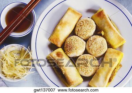 High angle view of spring rolls and dumpling in a plate with bean sprouts and dip, China View Large Photo Image Stock Photo - High angle view of spring rolls and dumpling in a plate with bean sprouts and dip, China. Fotosearch