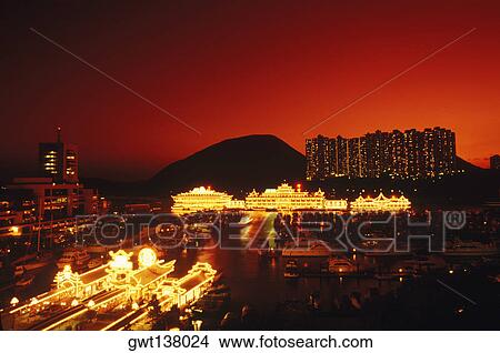 Buildings in a city lit up at night, Hong Kong, China View Large Photo Image Picture - Buildings in a city lit up at night, Hong Kong, China. Fotosearch