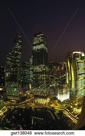 Buildings in a city lit up at night, Hong Kong, China View Large Photo Image Stock Photo - Buildings in a city lit up at night, Hong Kong, China. Fotosearch