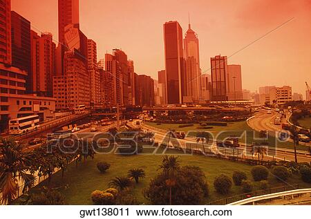 Stock Image - High angle view of a garden in front of skyscrapers, Hong Kong, China. Fotosearch