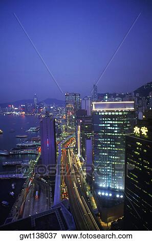 Stock Photo - High angle view of buildings in a city lit up at night, Hong Kong, China. Fotosearch