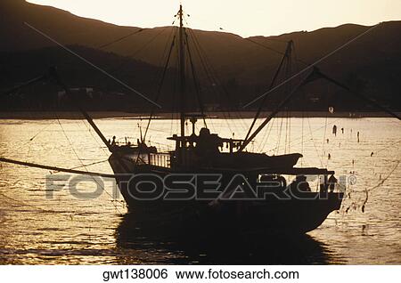 Silhouette of a ship at dusk, Hong Kong, China View Large Photo Image Stock Photograph - Silhouette of a ship at dusk, Hong Kong, China. Fotosearch