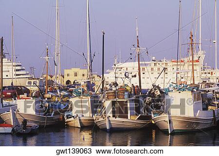 Boats moored at a harbor View Large Photo Image Stock Image - Boats moored at a harbor. Fotosearch